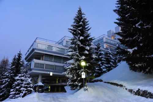 a building in the snow with a street light in front at Residenza Albaré in Marilleva
