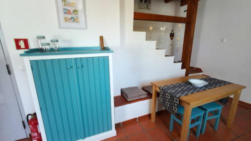 a room with a blue cabinet and a small table at Alentejo Colours Avis in Avis