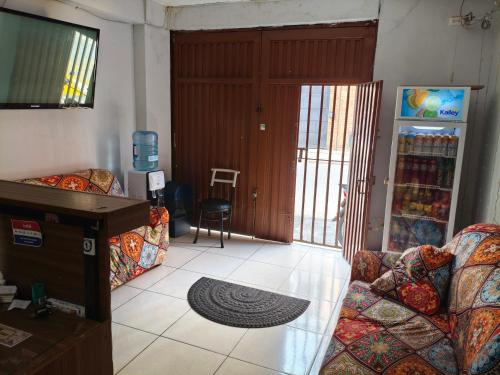 a living room with two couches and a television at Guayacan Hostel in Cali
