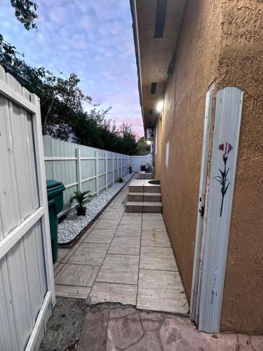 a hallway of a building with a door and a fence at Cozy room close to everything, 5min to the airport in Miami