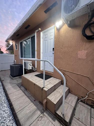 a house with a staircase leading to a door at Cozy room close to everything, 5min to the airport in Miami