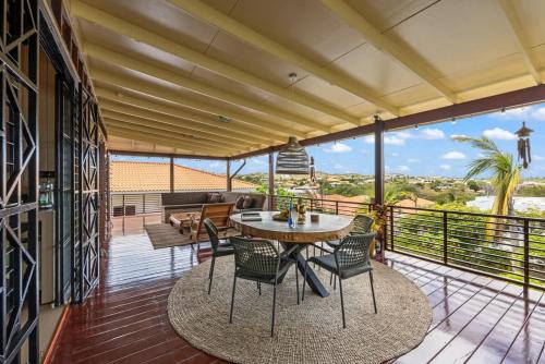 a patio with a table and chairs on a balcony at Bali Suites - Penthouse in Willemstad
