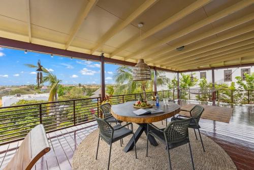 a patio with a table and chairs on a balcony at Bali Suites - Penthouse in Willemstad