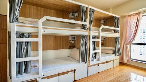 a room with three bunk beds in a house at Prestige holiday home Bed space in Dubai