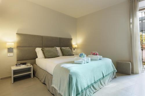 a bedroom with a large bed with two towels on it at Orta Paradise 26 in Orta San Giulio