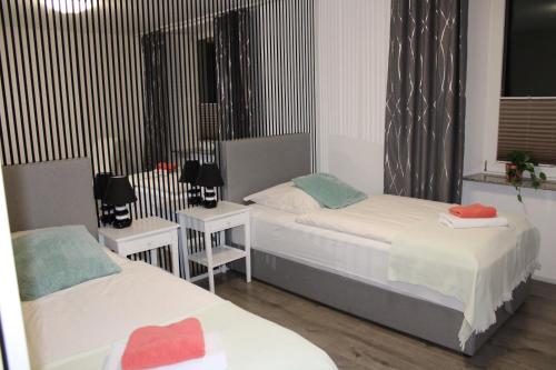 a bedroom with two beds and two night stands at Business Apartment Turgi in Turgi