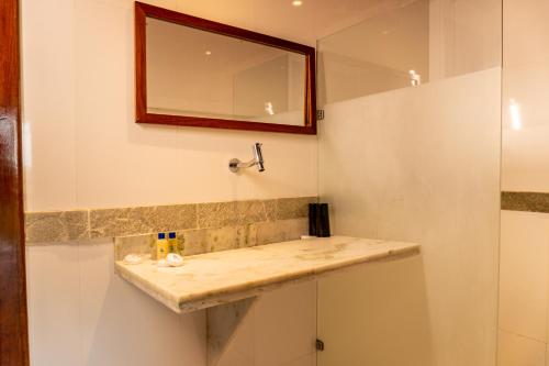 a bathroom with a sink and a mirror at Alizées Moreré in Ilha de Boipeba