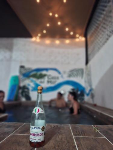 a bottle of water sitting on a table in a swimming pool at La casa del mar in Manzanillo