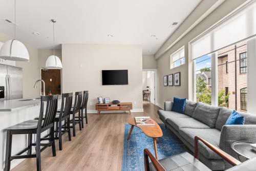 a kitchen and living room with a couch and a table at Mason Lofts at West End in Nashville