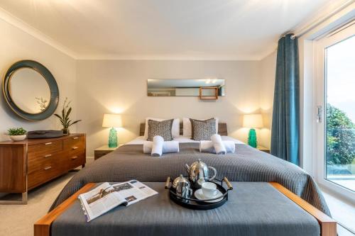 a bedroom with a large bed with a mirror and a window at 4 Bed in Carbis Bay oc-m30075 in Carbis Bay