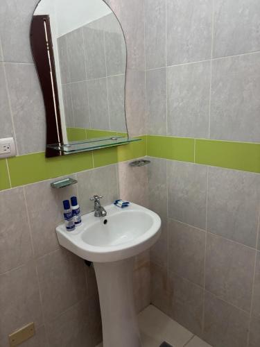 a bathroom with a sink and a mirror at Casa Bonita by Mireya in Bayahibe