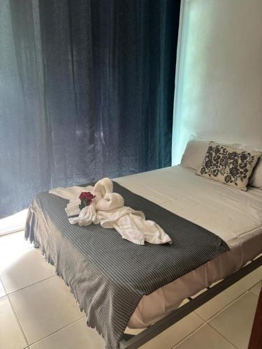 a bed with a towel on top of it at Casa Bonita by Mireya in Bayahibe