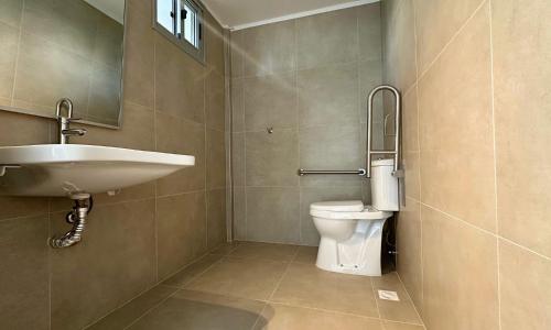 a bathroom with a sink and a toilet at Aguasol Hotel Termal in Termas del Daymán