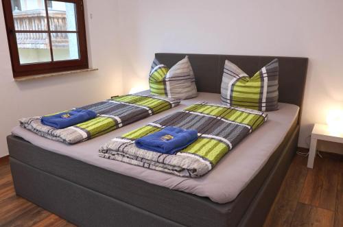 a couch with three pillows on top of it at Ferienwohnung Storchennest in Bad Liebenstein