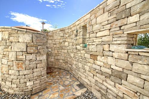 a stone retaining wall with a stone wall at Charming villa Darte with private pool near Rovinj, extra pool heating available in Kanfanar