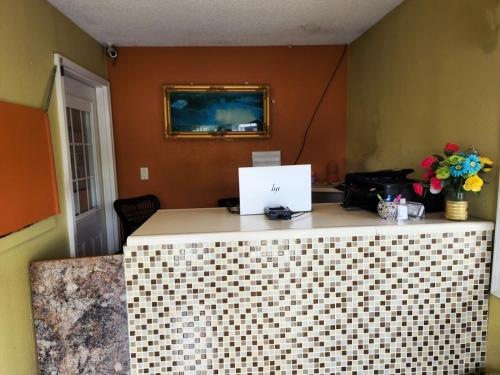 an office with a tile counter with a laptop on it at LACENTER MOTEL in La Center