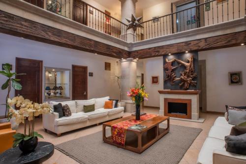 a living room filled with furniture and a fireplace at Hotel La Casona 30 in San Miguel de Allende