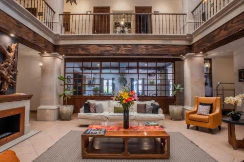 a living room filled with furniture and a fireplace at Hotel La Casona 30 in San Miguel de Allende