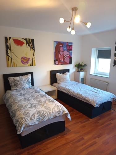 a bedroom with two beds and a window at Bebel apartments in Leverkusen