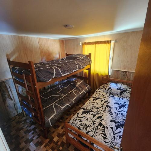 a small room with two bunk beds and a window at Paraíso Rustico 2 in Manzanar