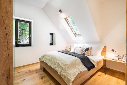 a bedroom with a bed and a window at Horský apartmán Kuba in Bedřichov