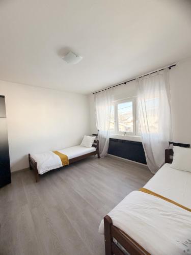 a room with two beds and a window at Bajkoviti kutak in Ogulin