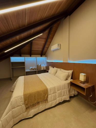 a bedroom with a large bed in a room at Loft Itália in Santa Teresa