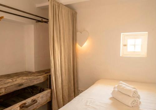 a bedroom with a bed with towels on it at Can Joseph I Can Toni Platera in Sant Francesc Xavier