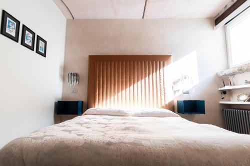 a bedroom with a large bed and a window at La suite del convento in Potenza