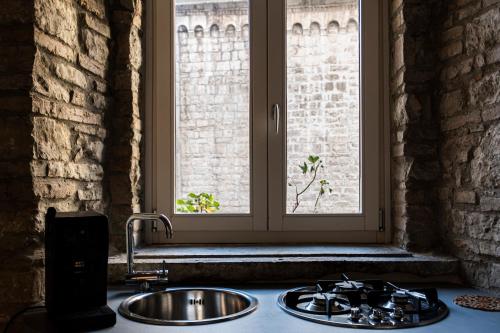 a kitchen counter with a sink and a window at La suite del convento in Potenza