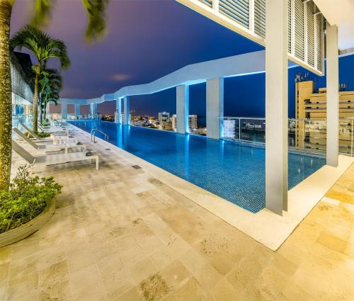 a swimming pool on the roof of a building at Cosmos Pacifico Hotel in Buenaventura