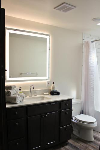 a bathroom with a sink and a toilet and a window at Two Bridges Lodge in Bailey