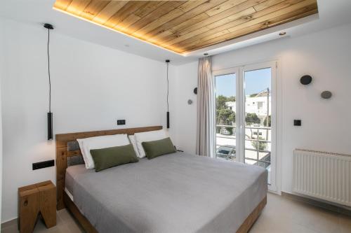a bedroom with a large bed and a balcony at Amelia villas Naxos in Naxos Chora