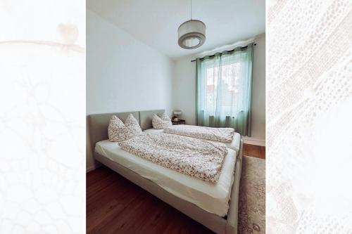 a bedroom with a bed and a window at Käferhain, App 135 in Groitzsch
