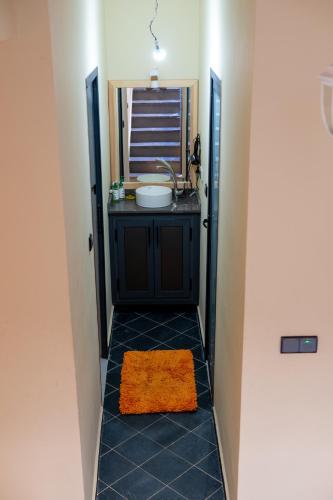 a bathroom with a sink and a mirror at Surf House Desert Point in Agadir
