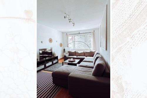 a living room with a couch and a tv at Käferhain, App 134 in Groitzsch
