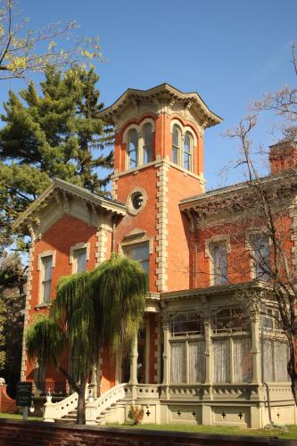 an old red brick building with a tall tower at Upjohn in Kalamazoo