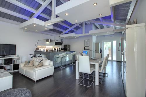 a living room with blue ceilings and white furniture at Charming villa Darte with private pool near Rovinj, extra pool heating available in Kanfanar