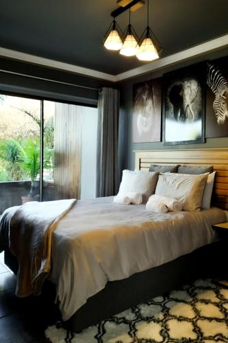 a bedroom with a large bed and a large window at RiverBanks in Wilderness