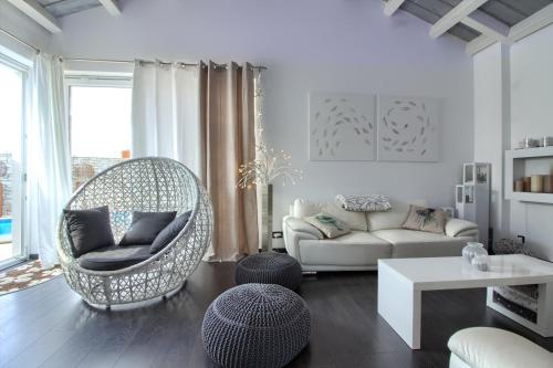 a living room with a wicker chair and a couch at Charming villa Darte with private pool near Rovinj, extra pool heating available in Kanfanar