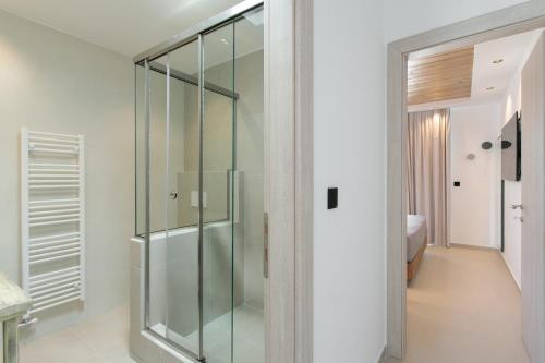 a glass shower stall in a bathroom with a sink at Amelia villas Naxos in Naxos Chora