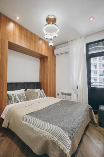 a bedroom with a large bed and a window at Avant Park GK Aparts in Baku
