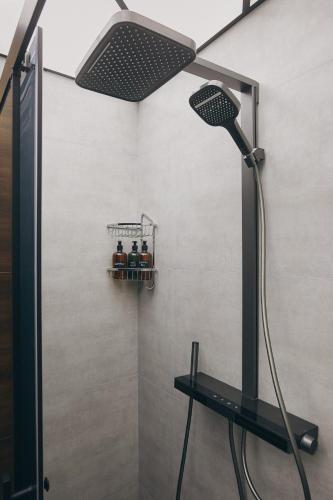 a shower with a shower head in a bathroom at Avant Park GK Aparts in Baku
