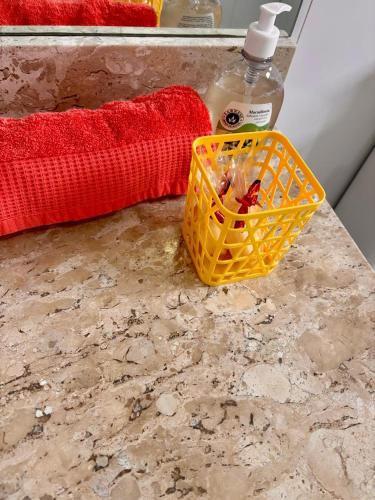 a basket on a counter with a bottle of soap at Conta desativada in São Luís