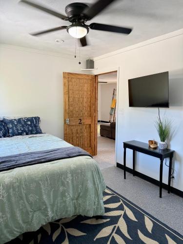 a bedroom with a bed and a flat screen tv at 4th Street Residences in Saint David