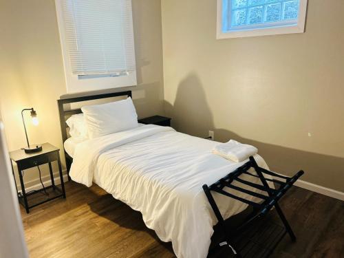 a bedroom with a bed with a chair and a window at Horace House Retreat in Saint Paul