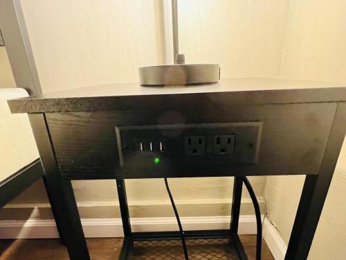 a table with an electrical outlet with a green light at Horace House Retreat in Saint Paul