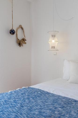 a bedroom with a bed with a blue rug on it at Utopia in Aljezur