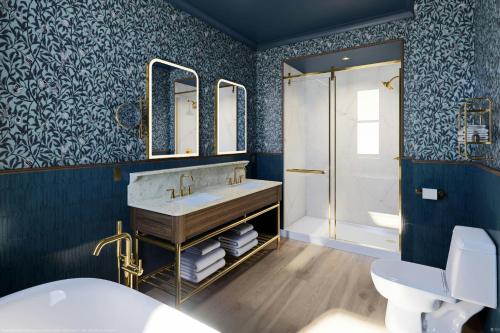 a bathroom with a sink and a shower at The Queen’s Cue, Stratford, A Tribute Portfolio Hotel in Stratford