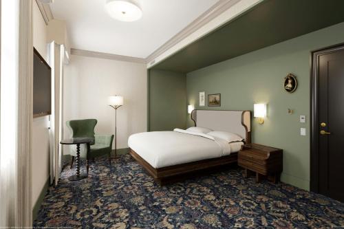 a bedroom with a bed and a green wall at The Queen’s Cue, Stratford, A Tribute Portfolio Hotel in Stratford